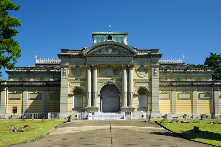 The domed stone entrance of the Nara National Museum's original building, with paired columns either side of an arched doorway, under a clear blue sky.